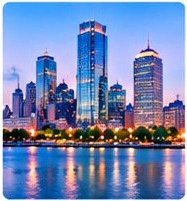 Boston skyline along the river at dusk